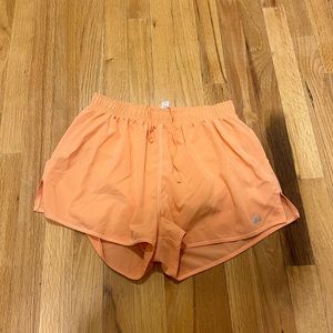 Alo Orange Shorts size medium (never worn!)